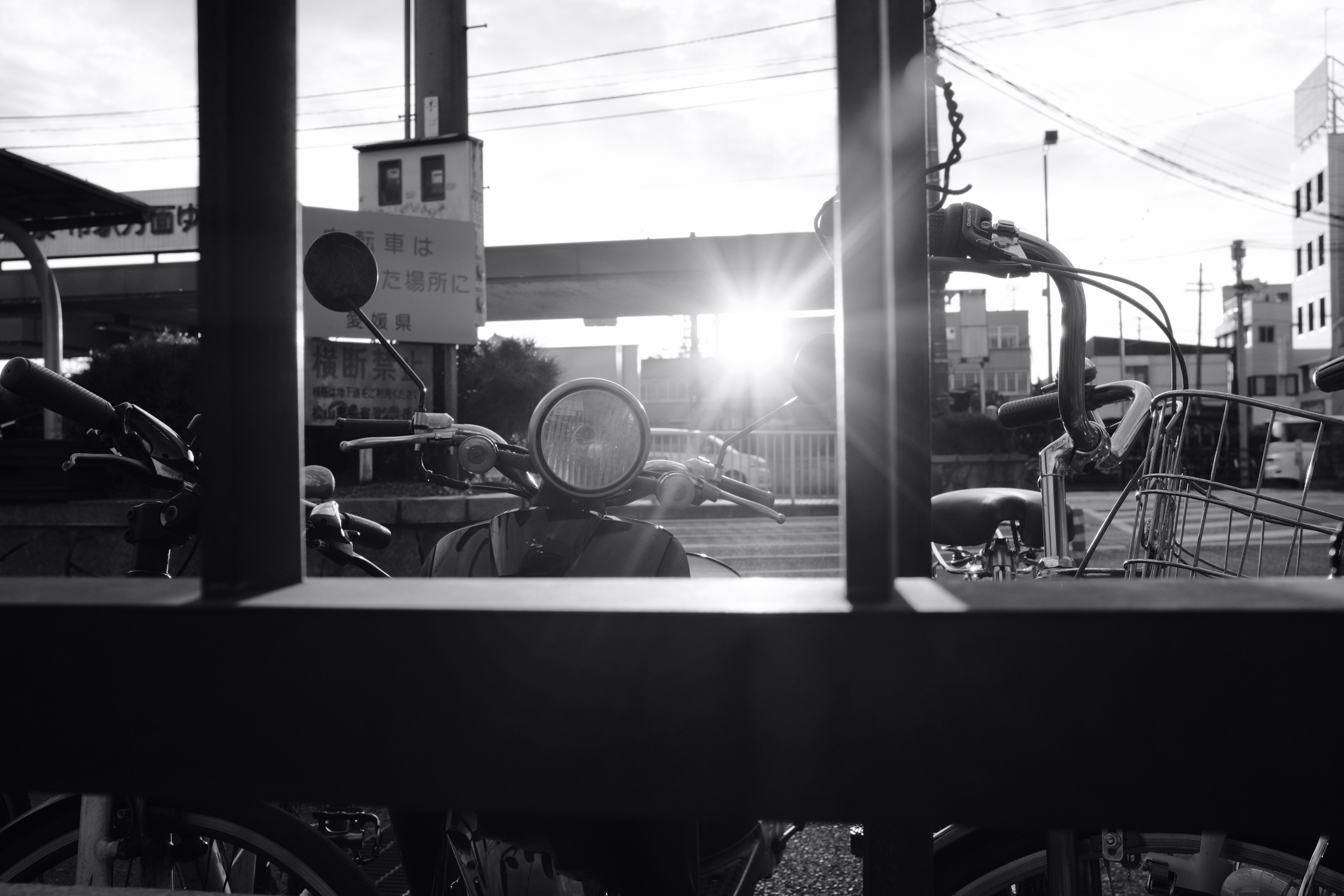 grayscale photo of motorcycle in a parking lot